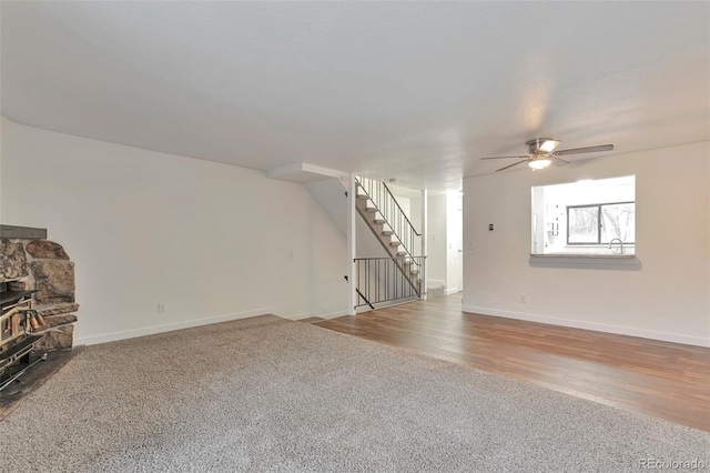 unfurnished living room with carpet flooring, ceiling fan, and a fireplace