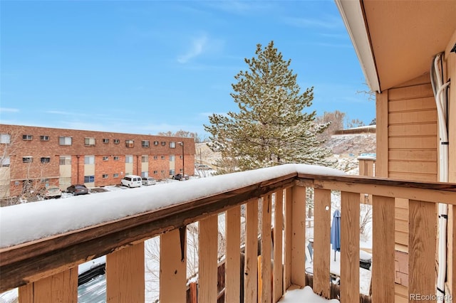 view of snow covered back of property