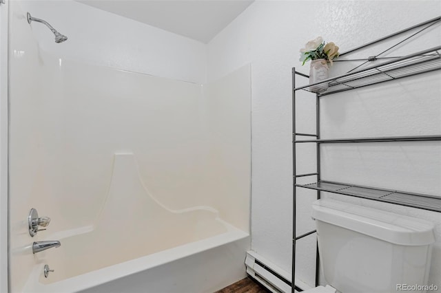 bathroom featuring shower / bathing tub combination, a baseboard radiator, and toilet