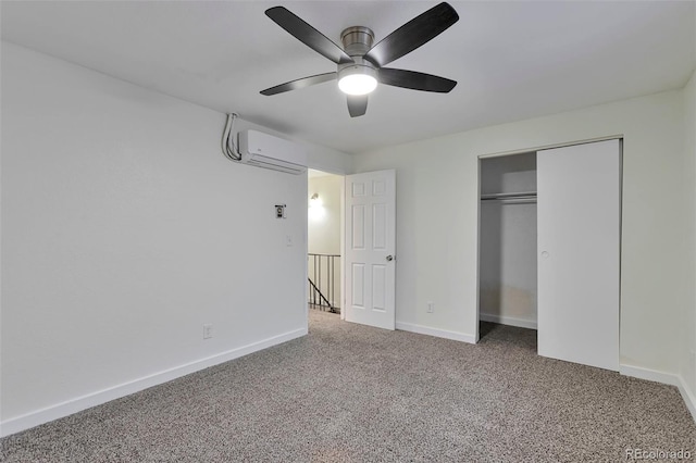 unfurnished bedroom with a wall unit AC, ceiling fan, a closet, and carpet floors