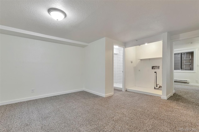 interior space with carpet floors, a textured ceiling, and a baseboard heating unit