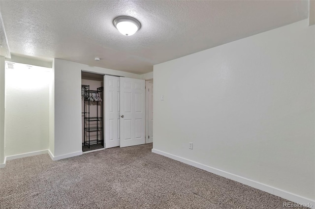 carpeted spare room with a textured ceiling