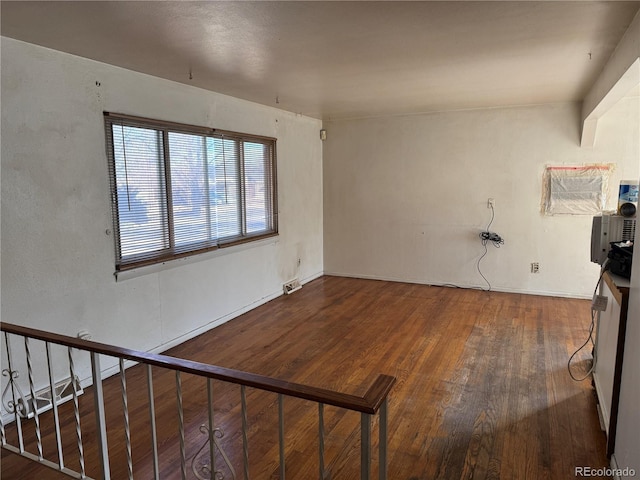 unfurnished living room with dark hardwood / wood-style floors