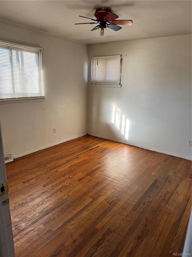 spare room featuring dark hardwood / wood-style floors and ceiling fan