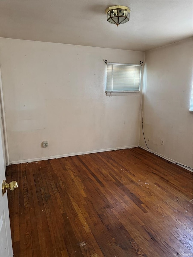 unfurnished room featuring dark hardwood / wood-style flooring