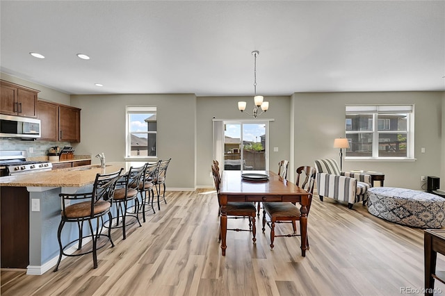 7888 E 139th Pl, Brighton, CO 80602 - dining space featuring light wood finished floors, a chandelier, and recessed lighting