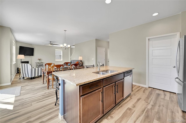 7888 E 139th Pl, Brighton, CO 80602 - kitchen with appliances with stainless steel finishes, light wood finished floors, light stone countertops, pendant lighting, and recessed lighting
