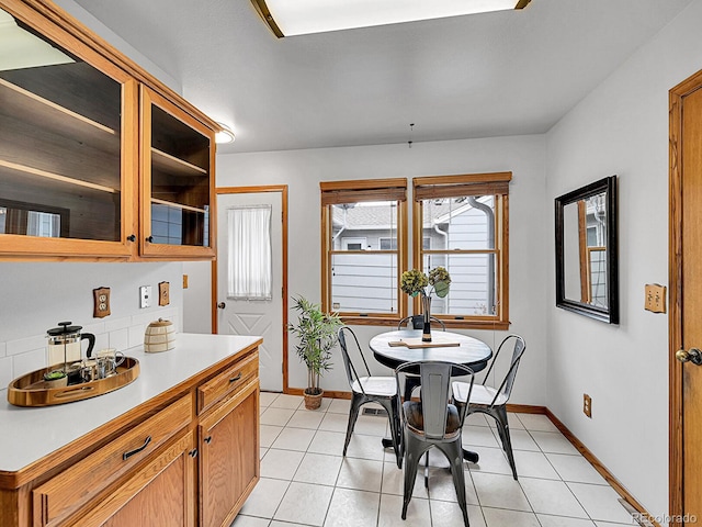 dining space with baseboards and light tile patterned floors