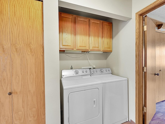 laundry area with cabinet space and washing machine and clothes dryer