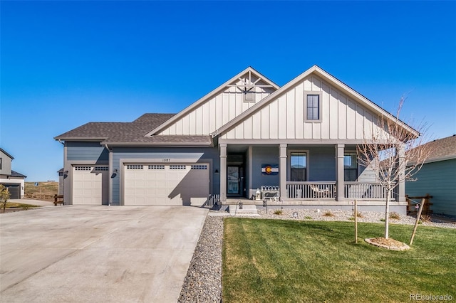 view of front of house featuring a front lawn, a porch, concrete driveway, a garage, and board and batten siding