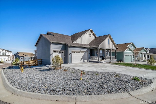 view of front of property with a residential view, board and batten siding, driveway, a porch, and a garage