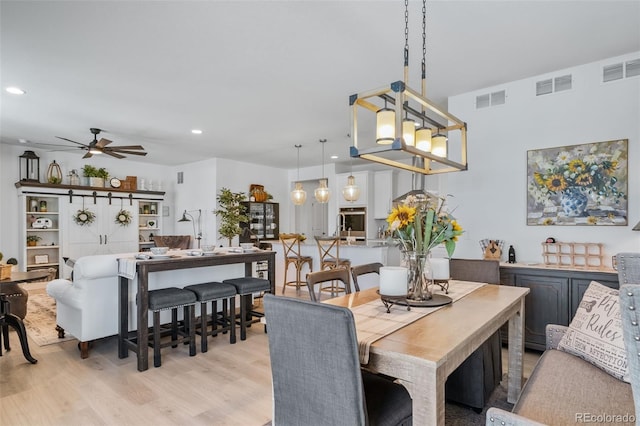 dining room with light wood finished floors, visible vents, recessed lighting, and ceiling fan