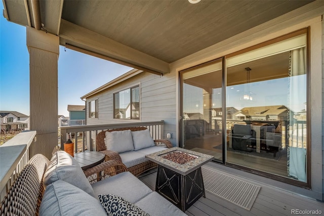 balcony with an outdoor living space with a fire pit