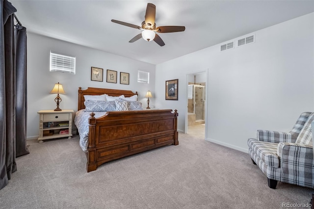 bedroom with ensuite bath, light carpet, visible vents, and baseboards