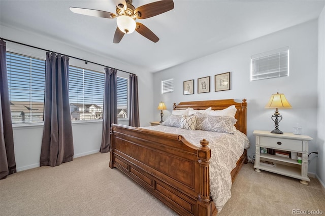 bedroom featuring ceiling fan, baseboards, and light carpet