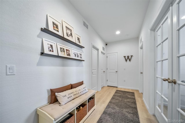interior space featuring recessed lighting, light wood-type flooring, and visible vents