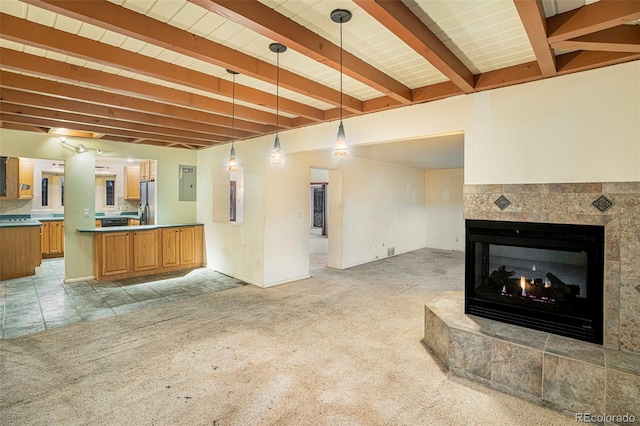 968 Terrace Cir, Colorado Springs, CO 80904 - unfurnished living room with electric panel, beam ceiling, a tile fireplace, light tile patterned floors, and light colored carpet