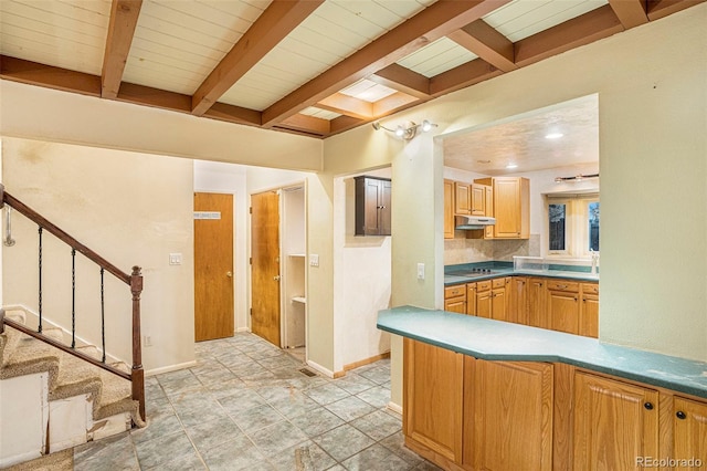 968 Terrace Cir, Colorado Springs, CO 80904 - kitchen with black electric stovetop, baseboards, beamed ceiling, and under cabinet range hood