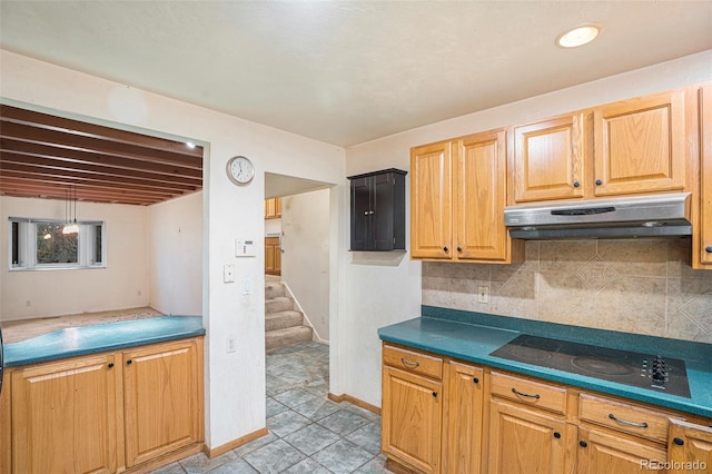 968 Terrace Cir, Colorado Springs, CO 80904 - kitchen featuring tasteful backsplash, black electric stovetop, baseboards, under cabinet range hood, and dark countertops