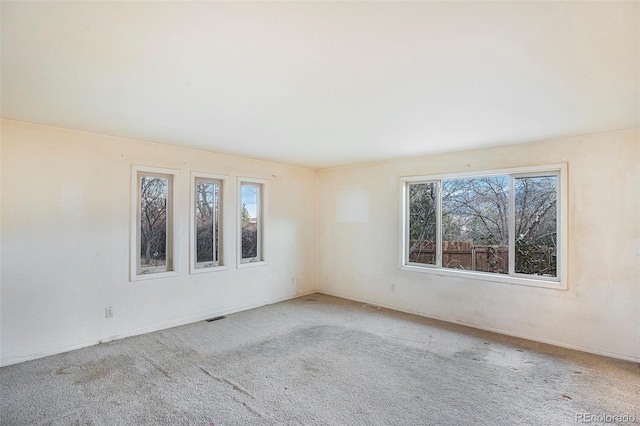 968 Terrace Cir, Colorado Springs, CO 80904 - carpeted empty room with a wealth of natural light and visible vents