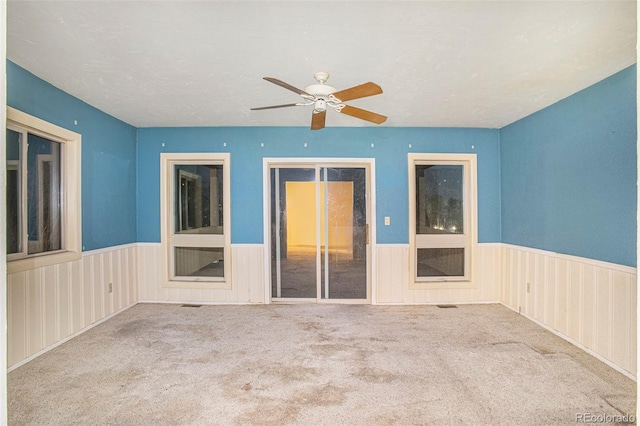 968 Terrace Cir, Colorado Springs, CO 80904 - carpeted spare room with a wainscoted wall and a ceiling fan