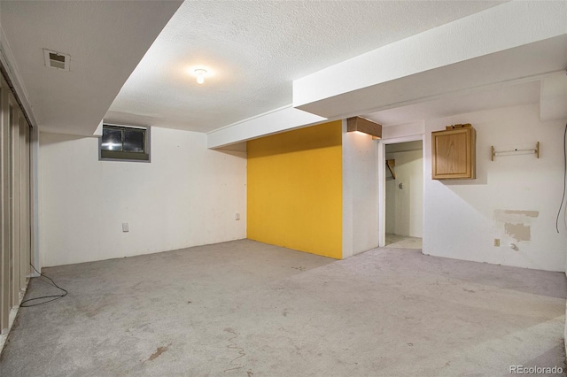 968 Terrace Cir, Colorado Springs, CO 80904 - finished basement featuring light colored carpet, visible vents, and a textured ceiling