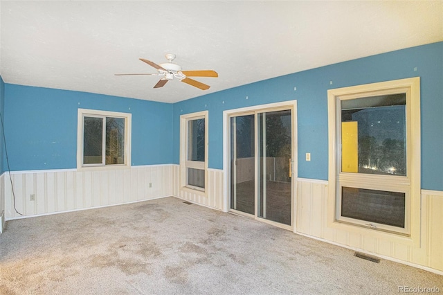 968 Terrace Cir, Colorado Springs, CO 80904 - carpeted empty room featuring visible vents, ceiling fan, and wainscoting