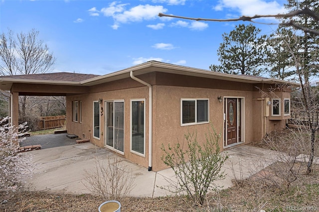 968 Terrace Cir, Colorado Springs, CO 80904 - back of property featuring a patio, fence, and stucco siding