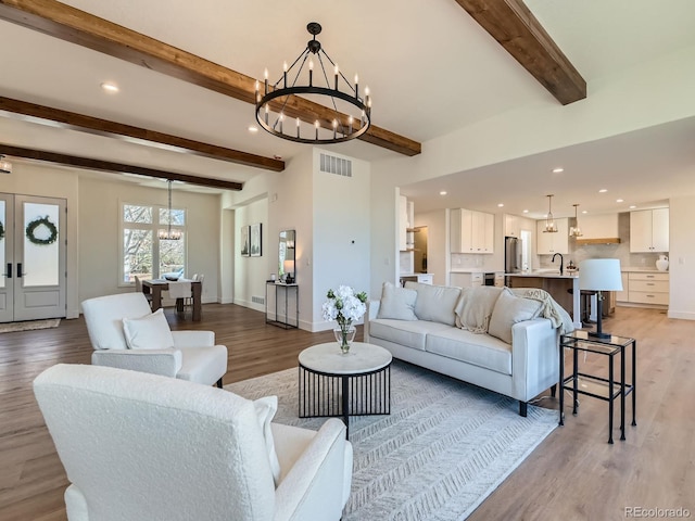 living area featuring a chandelier, visible vents, and recessed lighting