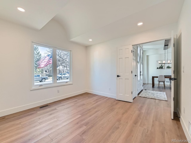 interior space with light wood-style flooring, recessed lighting, visible vents, and baseboards