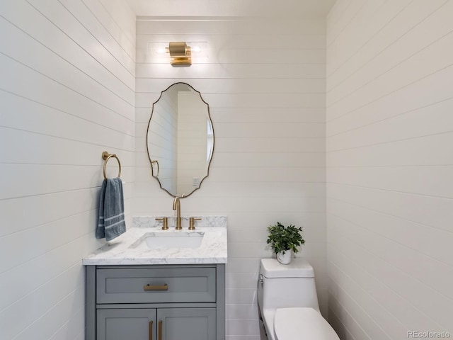 half bathroom with toilet and vanity