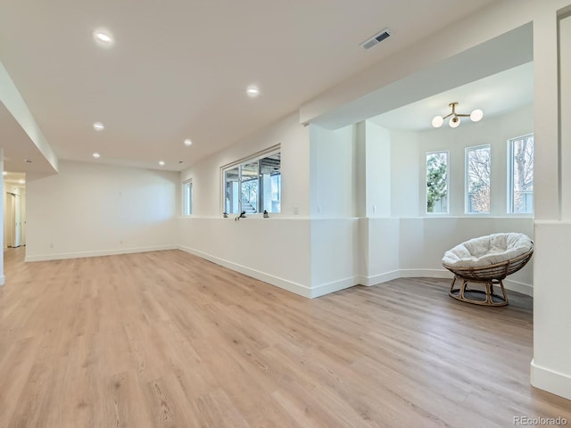 interior space featuring light wood finished floors, visible vents, and baseboards