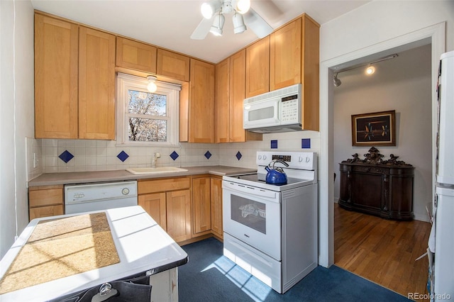 kitchen with a ceiling fan, a sink, backsplash, white appliances, and light countertops