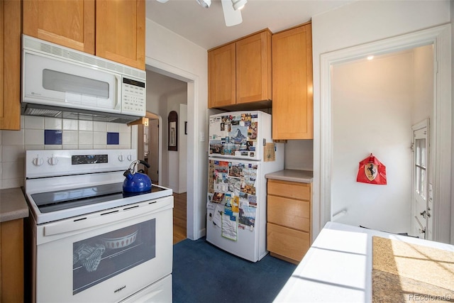 kitchen with white appliances, light countertops, and tasteful backsplash