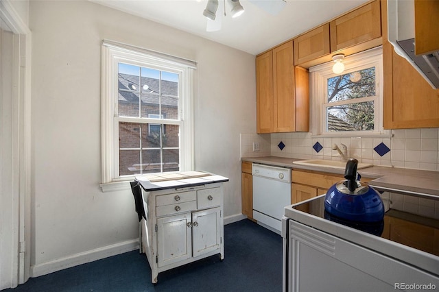 kitchen with white appliances, baseboards, ceiling fan, a sink, and tasteful backsplash