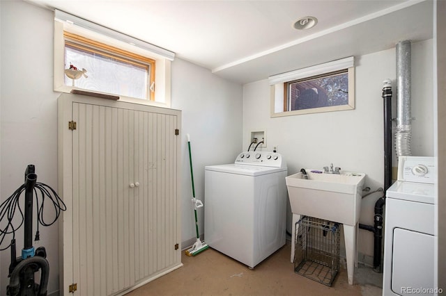 laundry area featuring a sink, laundry area, and washer and clothes dryer