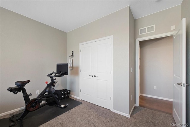 workout area with carpet floors, baseboards, and visible vents
