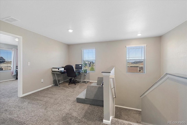 carpeted office with a healthy amount of sunlight, baseboards, recessed lighting, and visible vents