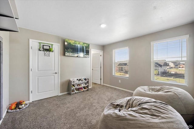 living room with baseboards and carpet