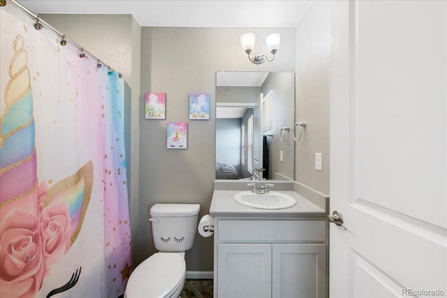bathroom featuring toilet and vanity