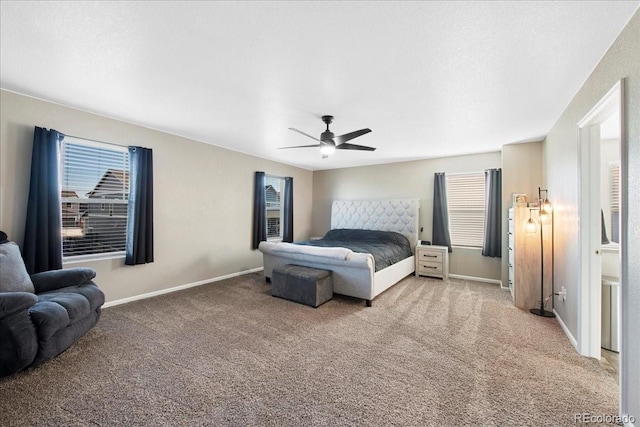 bedroom with a ceiling fan, baseboards, and light colored carpet