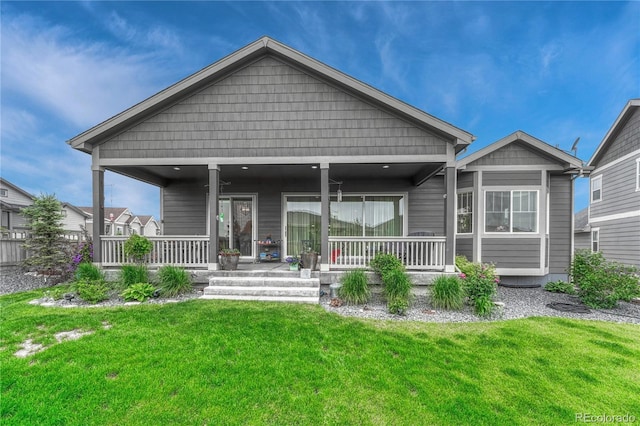 2932 Eagle Wing Way, Castle Rock, CO 80109 - rear view of house with covered porch and a lawn
