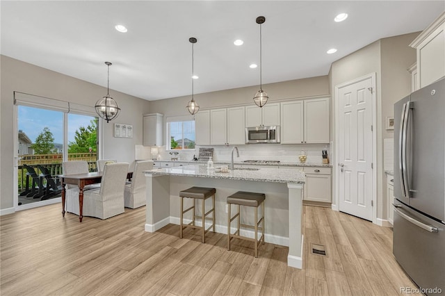 2932 Eagle Wing Way, Castle Rock, CO 80109 - kitchen featuring appliances with stainless steel finishes, light wood-style flooring, white cabinets, a sink, and recessed lighting