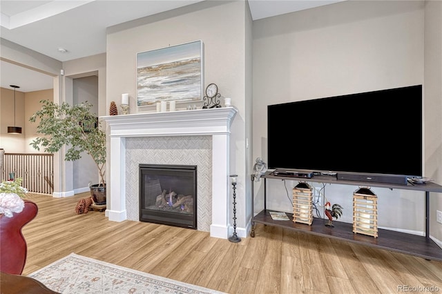 2932 Eagle Wing Way, Castle Rock, CO 80109 - living area with wood finished floors, baseboards, and a tile fireplace