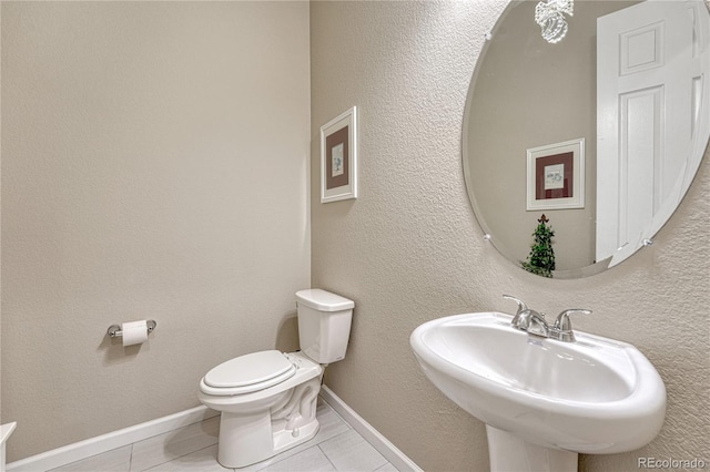 2932 Eagle Wing Way, Castle Rock, CO 80109 - bathroom featuring tile patterned floors, toilet, a sink, and baseboards