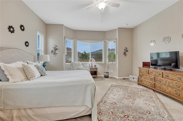 2932 Eagle Wing Way, Castle Rock, CO 80109 - bedroom featuring light colored carpet, multiple windows, baseboards, and a ceiling fan