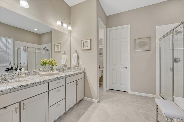 2932 Eagle Wing Way, Castle Rock, CO 80109 - full bathroom with a shower stall, double vanity, toilet, and baseboards