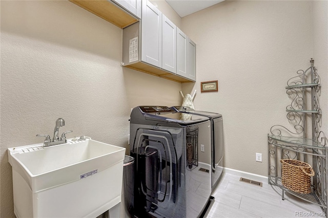 2932 Eagle Wing Way, Castle Rock, CO 80109 - washroom with cabinet space, separate washer and dryer, baseboards, and a textured wall