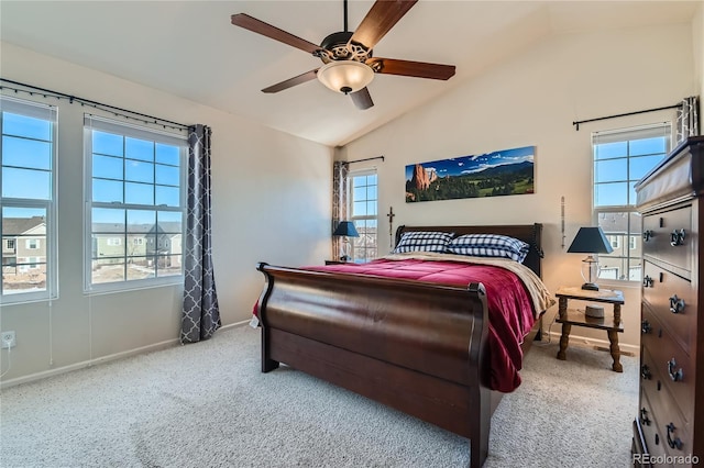 bedroom with ceiling fan, lofted ceiling, and carpet flooring