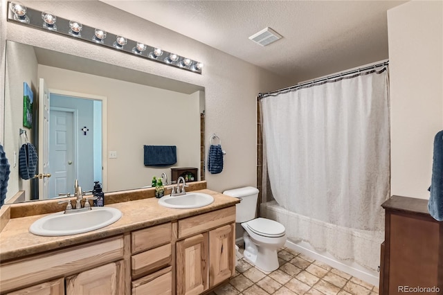 full bathroom with vanity, toilet, a textured ceiling, and shower / bathtub combination with curtain